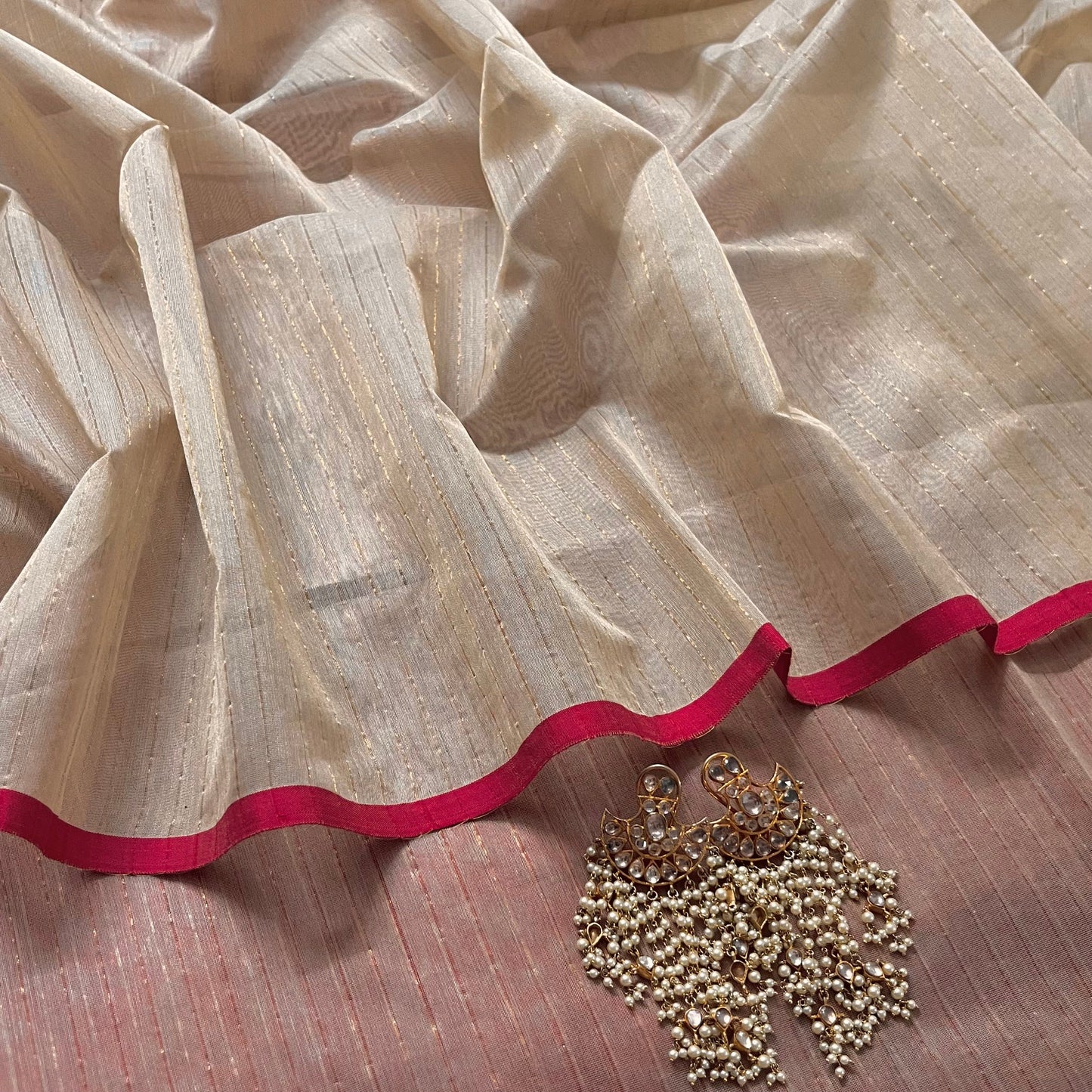 Light beige and red Maheshwari saree with zari lines all over