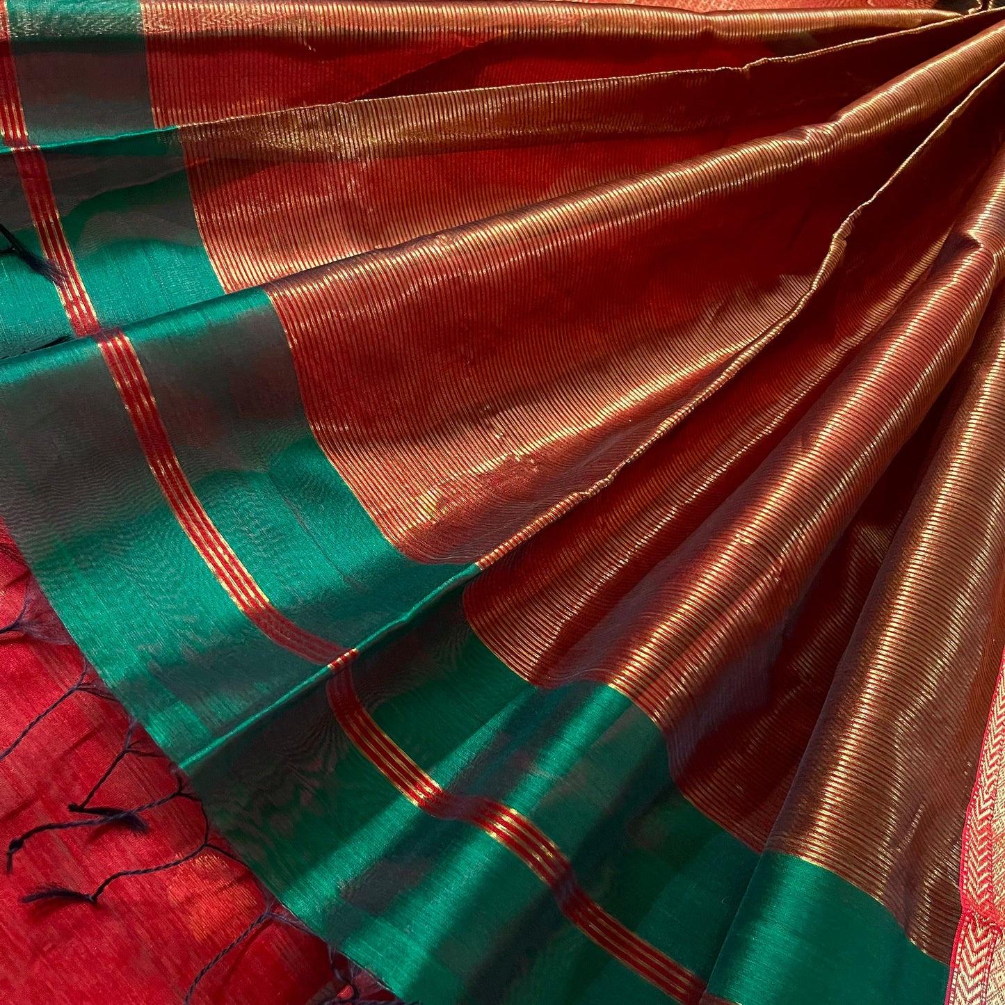Dark green and red Maheshwari saree with flower motifs all over