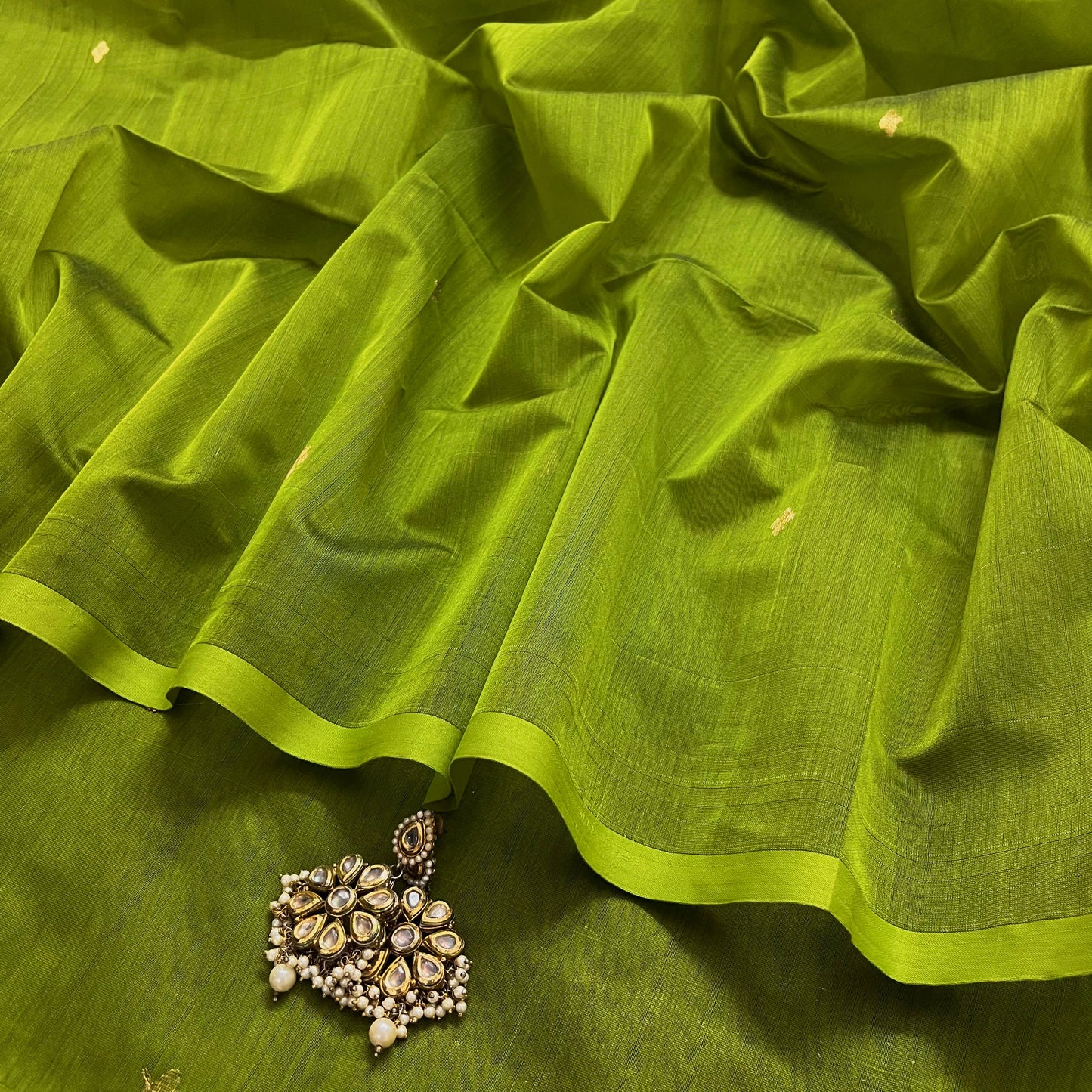 Olive green maheshwari saree with zari bootis all over
