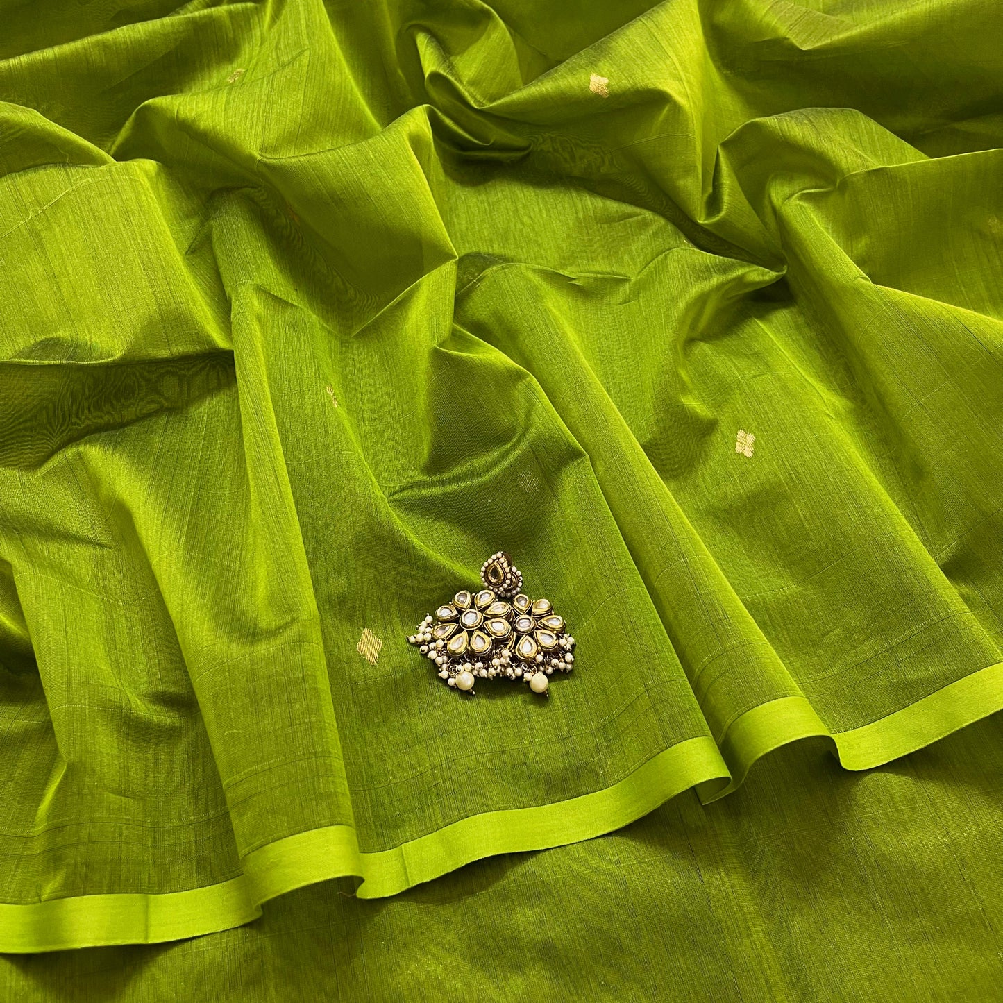 Olive green maheshwari saree with zari bootis all over