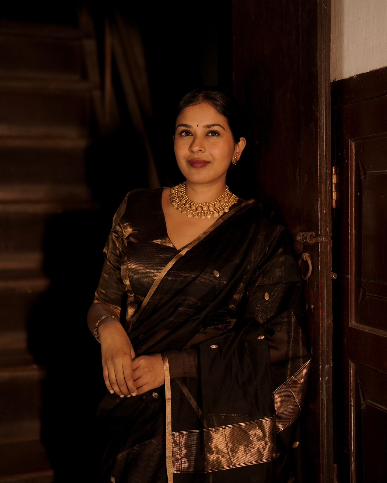Black and gold maheshwari saree with zari bootis and zari lines all over