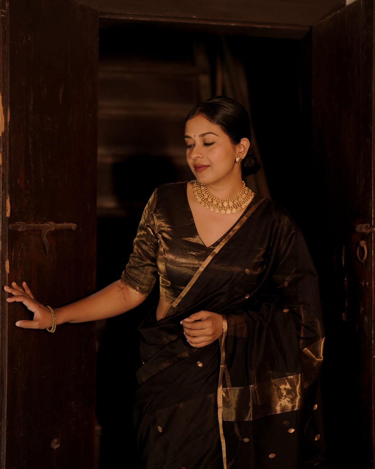 Black and gold maheshwari saree with zari bootis and zari lines all over